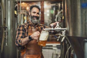 ein Brauerei Meister Verkostung Bier im das Produktion Einrichtung. foto