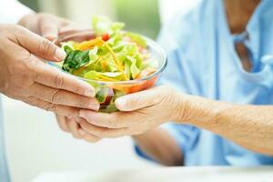 asiatisch Ernährungsberater halten gesund Essen zum geduldig im Krankenhaus, Ernährung und Vitamin. foto