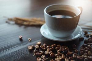 Kaffeetasse auf Holzschreibtisch im Café - Vintage-Effekt. foto