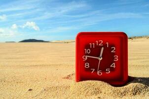 Uhr auf dem Sand foto