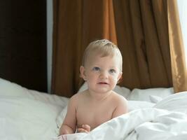 blond Blau Augen Baby auf das Bett foto