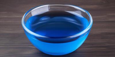 klein Glas Schüssel mit Blau Flüssigkeit im es ai generiert foto