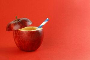 Gesundheit rot Schnitt Apfel recycelbar Papier Stroh Saft trinken Idee Konzept auf rot Hintergrund foto