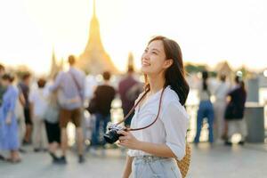 Porträt jung schön asiatisch Frau lächelnd während Reise beim wat arun Sonnenuntergang Aussicht Punkt, Bangkok, Thailand. foto