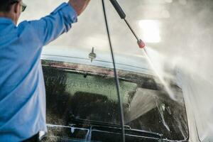 Kaukasier Auto waschen Arbeiter reinigt Klient Wagen. foto