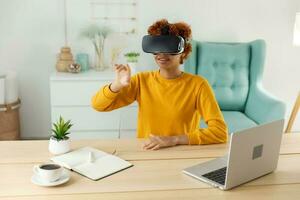 afrikanisch amerikanisch jung Frau tragen mit virtuell Wirklichkeit Metaverse vr Brille Headset beim heim. Mädchen berühren Luft während vr Erfahrung auf virtuell Wirklichkeit Helm. Simulation Hi-Tech Videospiel Konzept. foto