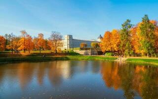 hell Herbst Landschaft mit Zustand Museum Reservieren Gatschina. sonnig Panorama- Herbst Aussicht von das Park, Karpin Teich und großartig Palast im das Ufer. foto
