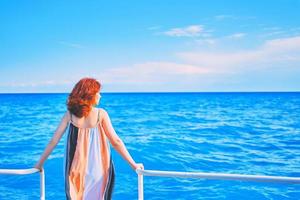 hinter Mädchen auf Pier mit Ozeanhintergrund foto