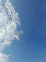 weiße Wolken am blauen Himmel. schöner hellblauer Hintergrund. leicht bewölkt, gutes Wetter. lockige Wolken an einem sonnigen Tag. foto