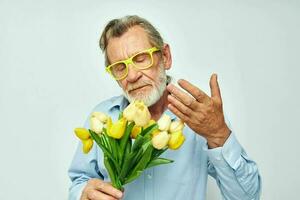 alt Mann ein Strauß von Blumen mit Brille wie ein Geschenk Licht Hintergrund foto