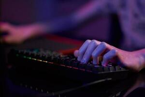 gamer spielen computerspiel, verwenden rgb neonfarbene tastatur foto