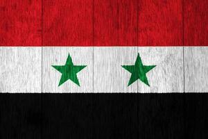 Flagge von syrisch arabisch Republik auf ein texturiert Hintergrund. Konzept Collage. foto