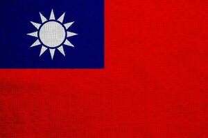 Flagge von Republik von China Taiwan auf ein texturiert Hintergrund. Konzept Collage. foto