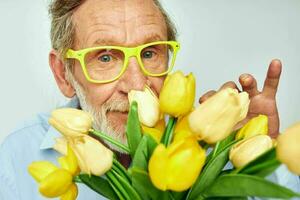 Porträt Alten Mann Gelb Strauß von Blumen posieren isoliert Hintergrund foto