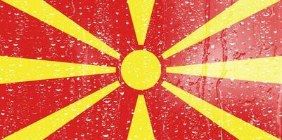 3d Flagge von Norden Mazedonien auf ein Glas mit Wasser fallen Hintergrund. foto