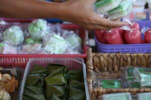 ein indonesisch Straße Essen Stall Verkäufer serviert durch Kunden. foto