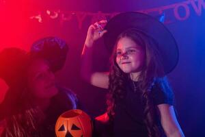 komisch Kind Mädchen und Frau im Hexen Kostüme zum Halloween mit Kürbis Jack. foto