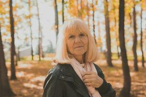 Senior Frau genießen Herbst im Park. aktiv Altern und Senior weiblich Konzept. foto