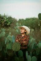 Mexikaner Mann mit Sombrero im ein Kaktus Landschaft foto