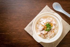 Porridge oder gekochte Reissuppe mit Fischschale foto