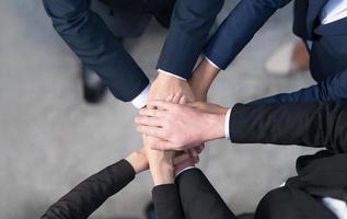Draufsicht, abgeschnittene Ansicht einer Gruppe von Geschäftsleuten, die ihre Hände zusammenlegen