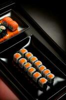 zwei Tabletts von Sushi auf ein schwarz Oberfläche. ai generiert foto