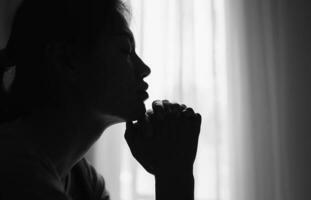 Silhouette einer religiösen jungen Frau, die morgens zu Gott betet, Spiritualität und Religion, Christen und Bibelstudienkonzept. foto