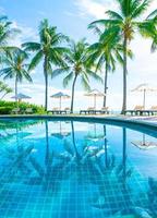 schöner Sonnenschirm und Stuhl um den Pool im Hotel und Resort? foto