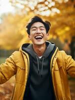 Foto von emotional dynamisch Pose asiatisch Mann im Herbst ai generativ