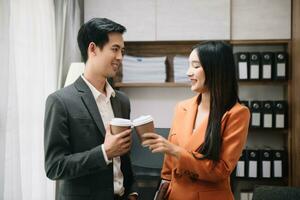 glücklich zwei asiatisch Geschäft Frau halten Kaffee Tasse im Coworking Büro foto