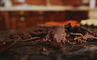 abgekühlt Schokolade Masse gesammelt mit ein Süßwaren Schaber auf ein Marmor Oberfläche. Konzept von Welt Schokolade Tag foto