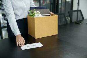 Geschäft Frau Senden Rücktritt Brief zu Boss und halten Zeug zurücktreten drücken oder Tragen Karton Box durch Schreibtisch im Büro foto