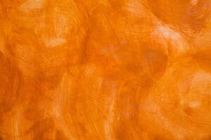 texturiert Mauer gebürstet gemalt Hintergrund, abstrakt Orange Öl Farbe. foto