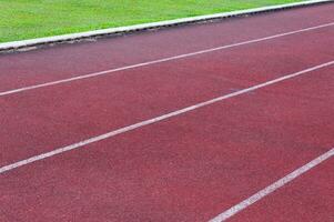 Laufen Spur und Grün Gras, direkt Leichtathletik Laufen Spur beim Sport Stadion foto