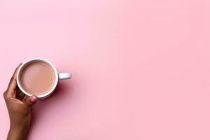 ai generiert, oben Aussicht von ein Hand halten ein Tasse von Kaffee. auf ein Pastell- Rosa Papier Hintergrund foto