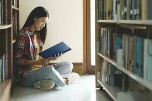 Universität Studenten lesen Bücher im Bibliothek zum Forschung. foto