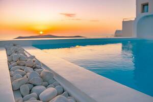 Infinity-Pool auf dem Dach bei Sonnenuntergang auf der Insel Santorini, Griechenland. schöner Pool- und Sonnenuntergangshimmel. luxuriöses Sommerurlaubs- und Urlaubskonzept, romantische Landschaft und Abendansicht foto