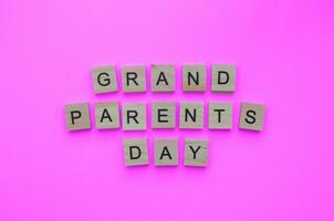 September 10, National Großeltern Tag, minimalistisch Banner mit das Inschrift im hölzern Briefe auf ein Rosa Hintergrund foto