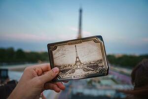 Person halten ein Foto von das Eiffel Turm im Paris