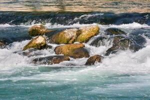 ein Fluss mit Stromschnellen und Felsen im es foto