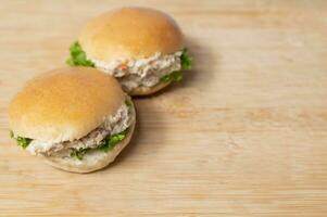 Seite Aussicht von Thunfisch Burger auf hölzern Tabelle foto