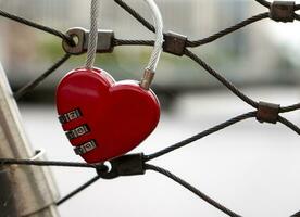 Herz sperren beim das Brücke, rot Herz sperren mit ein Code, Liebe und Leidenschaft Foto. ein Passwort von meine Herz Konzept foto