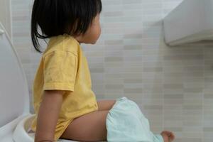 Kind gehen zu das Toilette, Verstopfung im Kinder, Dyspepsie, Bauch Schmerz, Weinen, Stuhlgang, anstrengen, Urin- Inkontinenz, Blut im das Schemel, Darm Probleme, Geschwür Kolitis, Durchfall foto