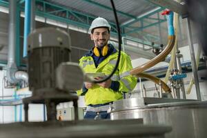 Ingenieure oder Fabrik Manager tragen Sicherheit Helm prüfen das Maschinen im das Produktion Linie. das Inspektor geöffnet das Maschine zu Prüfung das System zu Treffen das Standard. Maschine Instandhaltung foto