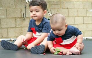 2 Jahre alt und 4 Monate alt Baby Brüder sind genießen auf Trampolin im das Zuhause Garten auf ein schön Tag Über Luton, England Vereinigtes Königreich. Herrlich schließen oben Bild war gefangen auf Juli 23., 2023 foto