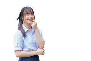 schön asiatisch hoch Schule Schüler Mädchen im das Schule Uniform mit lächelt selbstbewusst während sie sieht aus beim das Kamera glücklich während isoliert auf Weiß Hintergrund foto