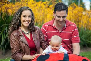 jung Eltern haben Spaß draußen mit ihr sechs Monate alt Baby Mädchen. Glück Konzept. Familie Konzept foto