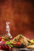 Italienisch Pasta Spaghetti mit Tomate Soße Olive Öl Basilikum und Parmesan Käse im alt schwenken foto
