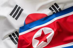 Norden und Süd Korea Flagge. bunt Süd und Norden Korea Flagge winken im das Wind foto