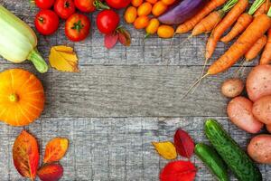 Sortiment verschiedenes frisches Bio-Gemüse auf Holzhintergrund im Landhausstil. gesundes essen veganes vegetarisches diätkonzept. lokaler Garten produziert saubere Nahrung. rahmen draufsicht flach liegend kopierraum. foto